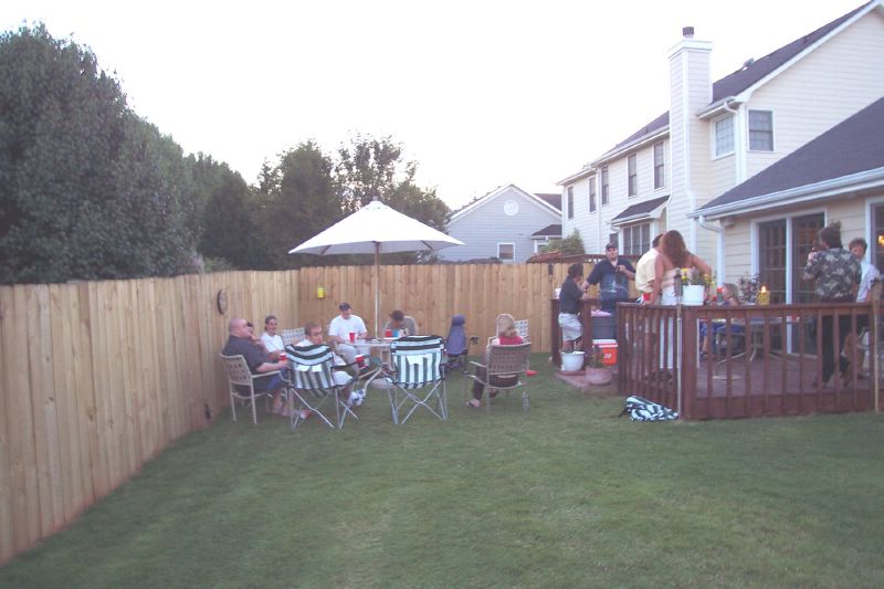 People drinking in the back yard