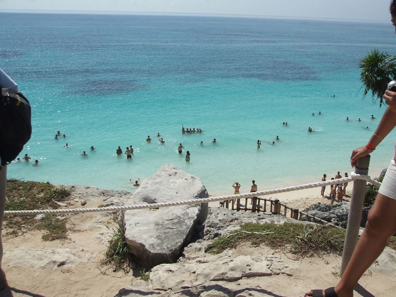 People playing in the ocean at Tulum